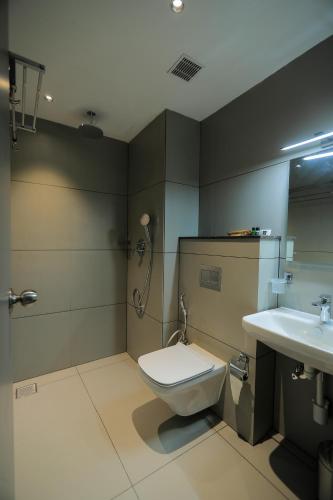 a bathroom with a toilet and a sink at Mount Land in Sultan Bathery