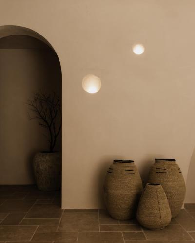 two vases sitting in the corner of a room at Momi Slow Living Hotel in Hersonissos