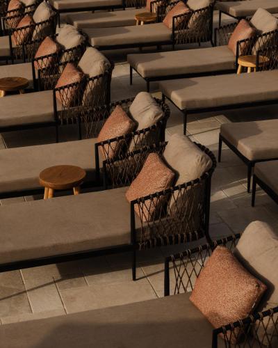 a row of tables and chairs in a room at Momi Slow Living Hotel in Hersonissos