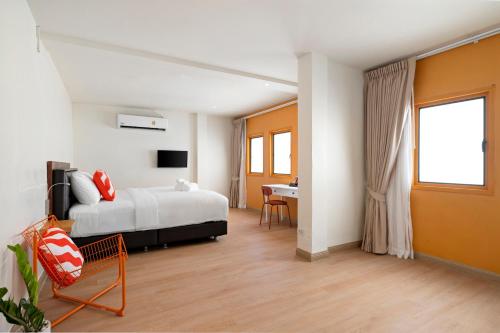 a bedroom with a bed and a desk in a room at Horange Phuket Town in Phuket
