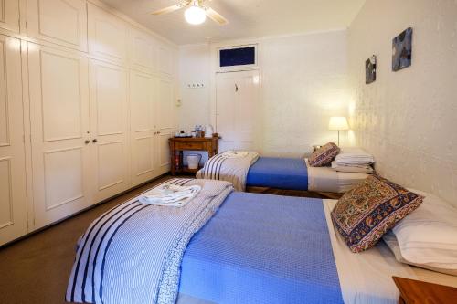 a bedroom with two beds and a ceiling at Peel Inn Hotel Nundle in Nundle
