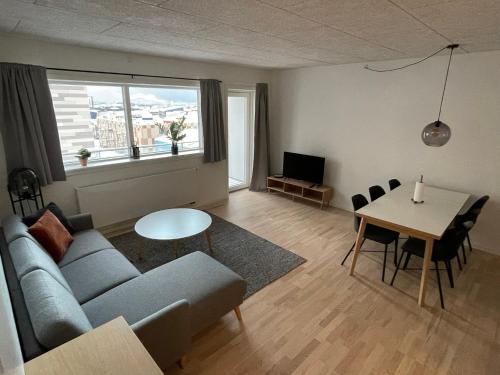 a living room with a couch and a table at inuit Bolig & Apartments in Nuuk