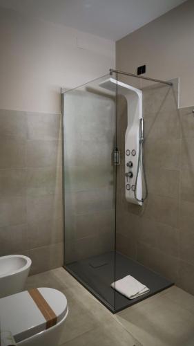 a bathroom with a shower with a toilet and a sink at TUISuneo La Conchiglia - Adults Only in Capo Vaticano