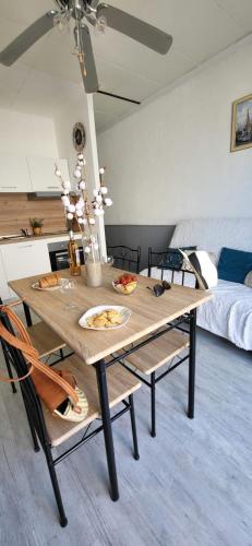 - un salon avec une table à manger et des chaises dans l'établissement La Mouette 2 pièces rénovées et climatisé 300 plage et commerces, au Grau-du-Roi