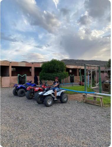 a person sitting on a four wheeler on a playground at Les cavaliers chez Yassine in Marrakech