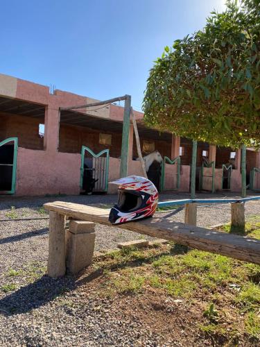 a helmet sitting on top of a wooden bench at Les cavaliers chez Yassine in Marrakech