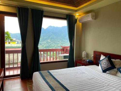 a bedroom with a bed and a large window at Botanic Sapa Hotel in Sa Pa