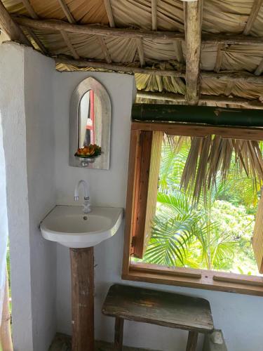 a bathroom with a sink and a window at Eco Casa Algana La Bambulera in El Limón