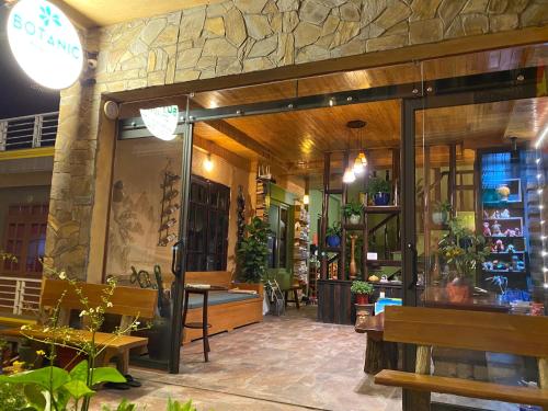 a store front with a bench and a stone wall at Botanic Sapa Hotel in Sa Pa