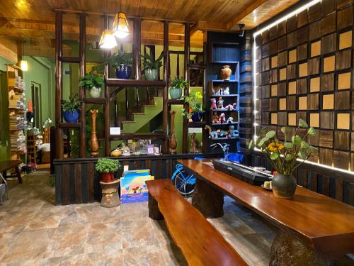 a room with a bench and shelves with plants at Botanic Sapa Hotel in Sa Pa
