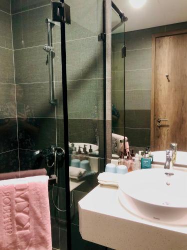 a bathroom with a white sink and a shower at Rose homestay Ecopark in HÆ°ng YÃªn