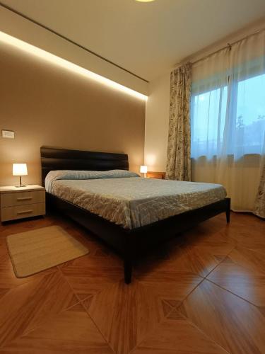 a bedroom with a bed and a large window at Chez Maison Grande in Aosta