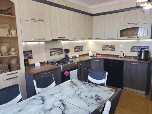 a kitchen with a table and a table and chairs at Batumi Aparthotel 22D in Batumi