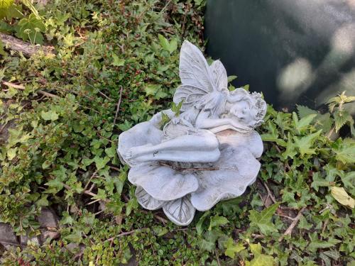 a statue of a fairy sitting on a flower at Swifts Nest in Carnguwch
