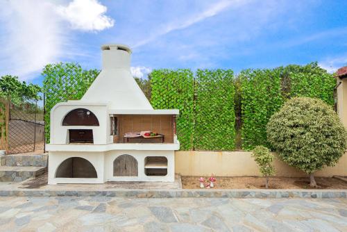 a dog house sitting on a patio next to a fence at Anastasia Veranna Villa in Lachania