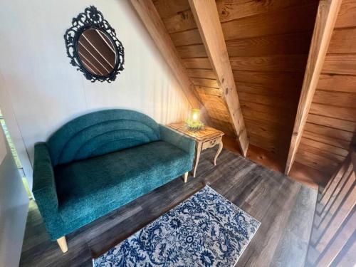a green couch in a room with a table at Cabin Nestled on Skiers Cove South Toledo Bend Lake 3 bedroom-5 beds in South Toledo Bend