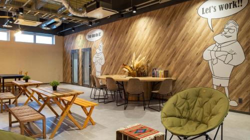 a restaurant with wooden walls and tables and chairs at EIGHT POINT INN Kanazawa in Kanazawa
