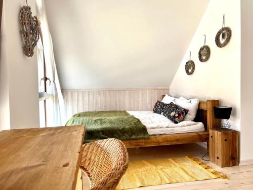a bedroom with a bed and a wooden table at Kaszubski Dom Ostoja Bukowo in Borowy Młyn