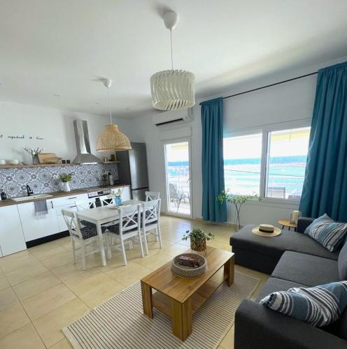 a living room with a couch and a table at Kima Sea Apartment in Nikiti