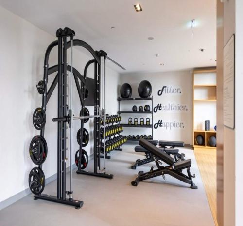 a gym with a lot of treadmills and weights at Luxury 1-Bedroom Apartment At Burj Crown. in Dubai