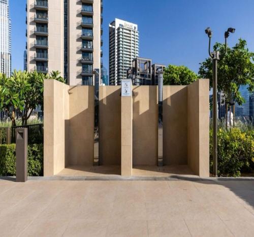 a sculpture in front of a building with tall buildings at Luxury 1-Bedroom Apartment At Burj Crown. in Dubai