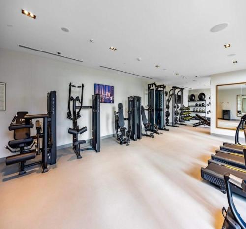 a gym with a row of tread machines at Luxury 1-Bedroom Apartment At Burj Crown. in Dubai