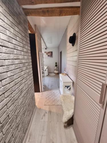 a hallway of a home with a stone wall at Boho Jura in Zawiercie