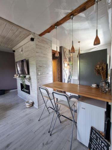 a dining room with a wooden table and chairs at Boho Jura in Zawiercie