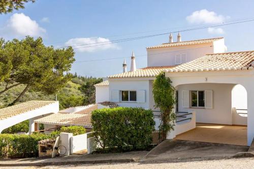 a white house with trees and bushes at Private 3 bedroom villa in Salema amazing views in Salema