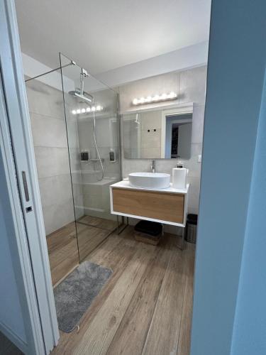 a bathroom with a sink and a shower at BOUTIQUE HOME LIGNANO in Lignano Sabbiadoro