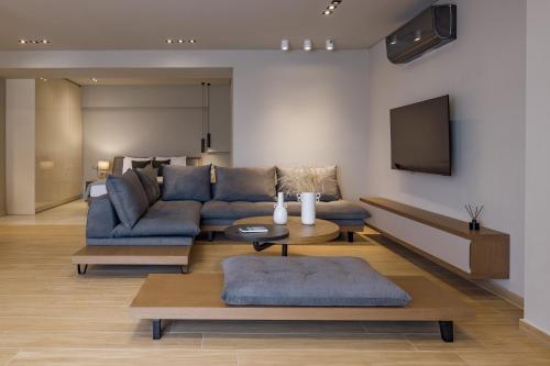 a living room with a couch and a tv at El Mar Naxos in Naxos Chora