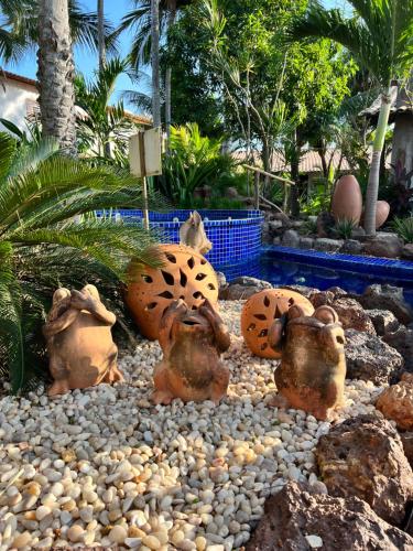a group of statues sitting on rocks in a garden at Pousada Vila Parnaíba in Parnaíba