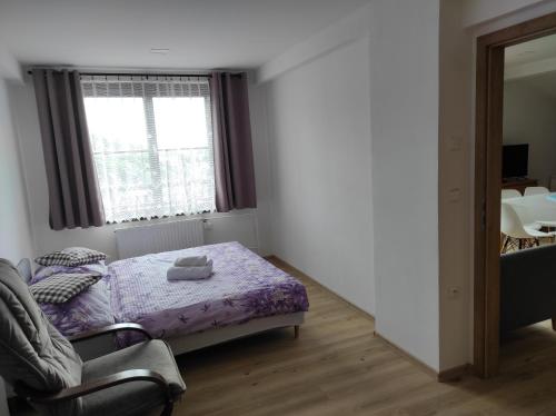 a small bedroom with a bed and a window at Pension Imlauf in Vrchlabí