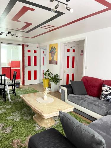 a living room with a couch and a coffee table at Westfield Gardens - 3 Bedroom Apartment in Goodmayes