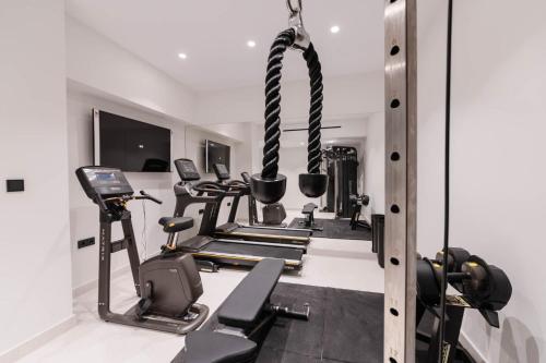 a gym with several treadmills and weights at Villa Lazareto in Kontokali