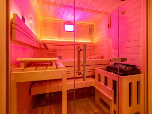a pink bathroom with a shower and a sink at Südwind's Deichperle in Westerland (Sylt)