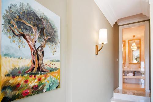 a painting of a tree on a wall in a hallway at Irida Parga in Parga