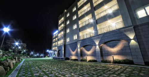 a building with lights on the side of it at night at Lapis Hotel Namhae in Namhae