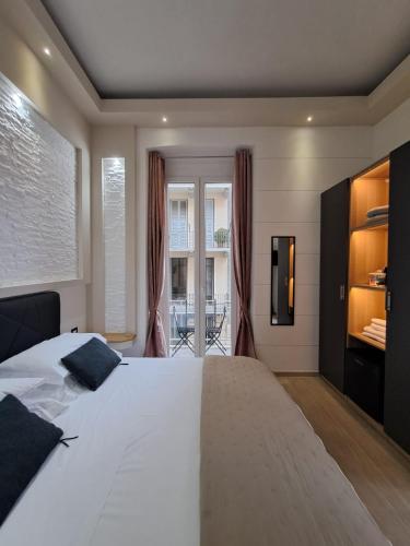 a bedroom with a large white bed and a balcony at La Siesta 5 terre in La Spezia