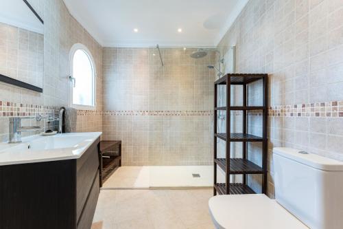 a bathroom with a sink and a toilet and a shower at Lovely apartment in peaceful area in Mijas