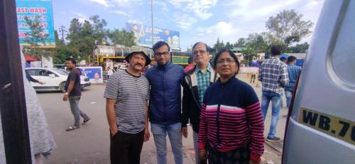 a group of people posing for a picture on a street at Swarna Kamal Homestay in Darjeeling