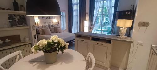 a room with a table with a vase of flowers on it at Carducci in Como