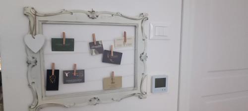 a mirror hanging on a wall with cards on it at Carducci in Como