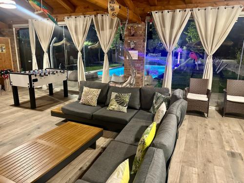 a living room with a couch and a pool table at Family Relais La Magnolia in Villanova dʼAsti