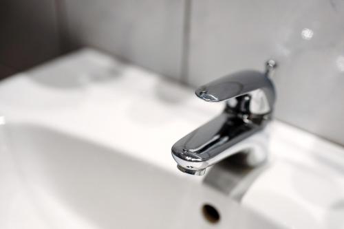 a bathroom sink with a chrome faucet at Grüner Ausblick in Oberkirch