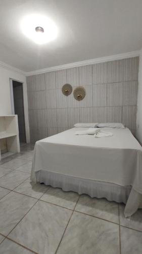 a bedroom with a white bed in a room at Ecomar Pousada in São José da Coroa Grande