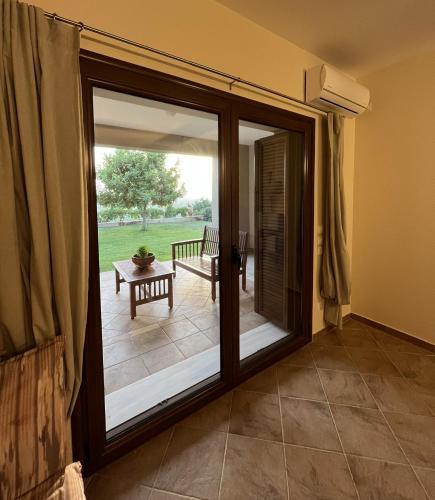 a room with a sliding glass door with a patio at Golden View Apartment 1 in Káto Samikón