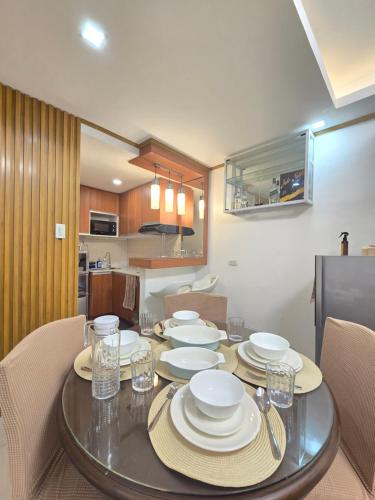 a dining room table with plates and glasses on it at Compostela Guest House with Car Park, Wifi, Netflix in Compostela