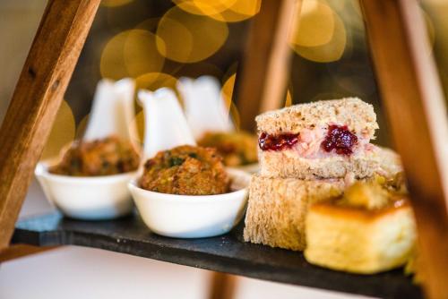 a bunch of food sitting on a black shelf at Blackwell House in Banbridge
