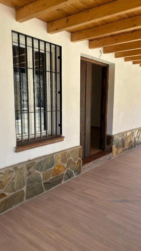 a porch of a house with wrought iron gates at Casa de huéspedes Arroyo Bujías - 3 habitaciones con baño privado individual in Alora